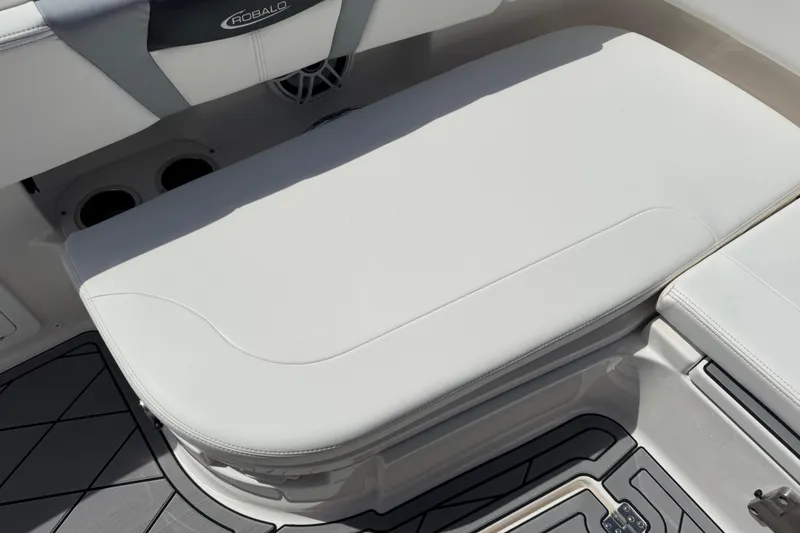 Slide: The Image of 2022 Robalo 266 Cayman boat interior with cushioned seating and cup holders. - 121