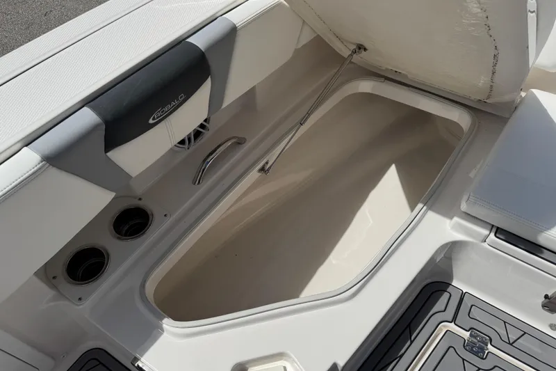 Slide: The Image of 2022 Robalo 266 Cayman boat storage compartment with open hatch and sleek design. - 122