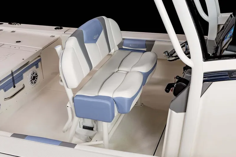 Slide: The Image of 2022 Robalo 266 Cayman boat on trailer, parked on a sunny street. - 14