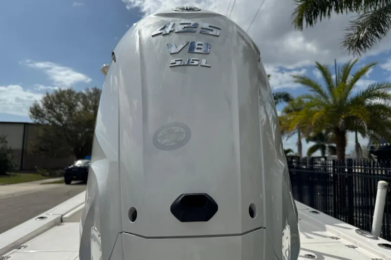 Slide: The Image of Close-up of a 2022 Robalo 266 Cayman boat component, featuring a metal bracket and black handle. - 21