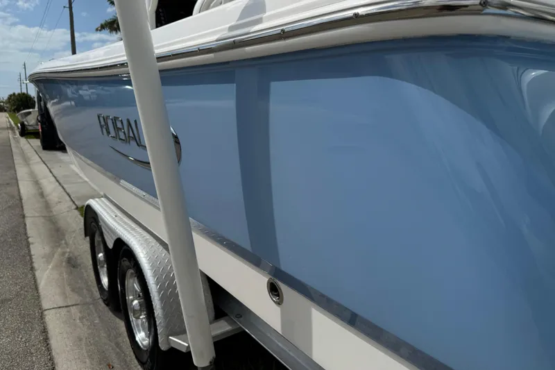 Slide: The Image of 2022 Robalo 266 Cayman boat propeller, shiny stainless steel, outdoor setting. - 23