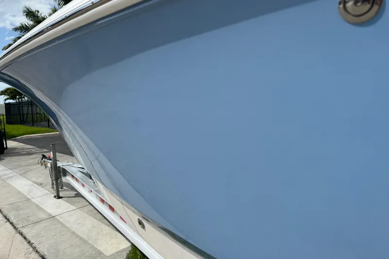 Slide: The Image of Yamaha XTO Offshore engine on 2022 Robalo 266 Cayman boat, palm trees background. - 26