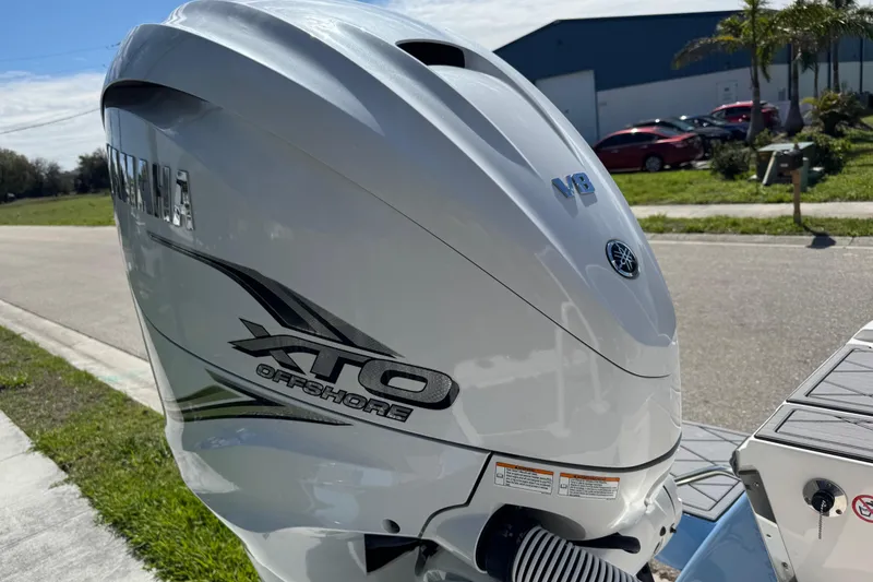 Slide: The Image of Yamaha XTO Offshore engine on 2022 Robalo 266 Cayman boat, parked outdoors. - 30