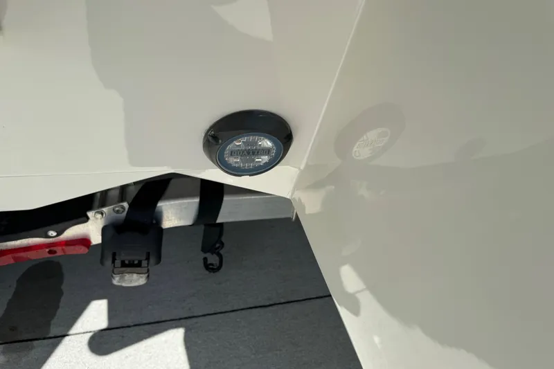 Slide: The Image of 2022 Robalo 266 Cayman boat detail with trailer hitch and light. - 33