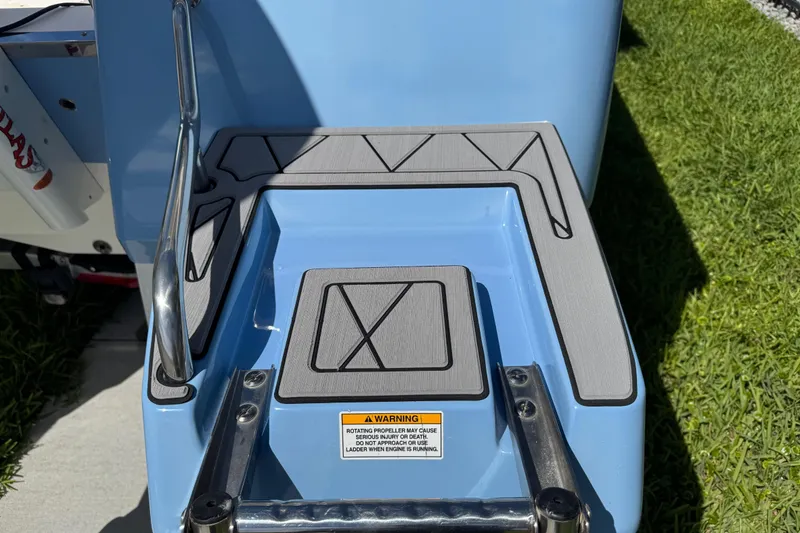 Slide: The Image of 2022 Robalo 266 Cayman boat step with safety warning label and sleek design. - 35