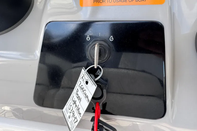 Slide: The Image of Key ignition panel of 2022 Robalo 266 Cayman boat with attached keychain. - 44