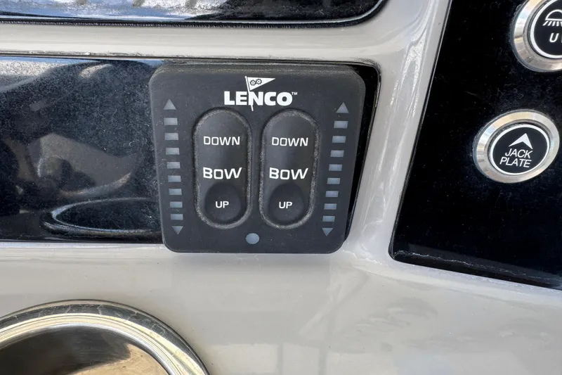 Slide: The Image of Lenco trim tab control panel on 2022 Robalo 266 Cayman boat dashboard. - 46