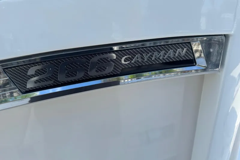 Slide: The Image of 2022 Robalo 266 Cayman boat emblem with sleek design and chrome accents. - 53