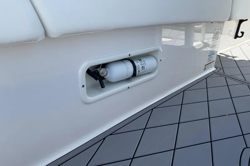 Slide: The Image of 2022 Robalo 266 Cayman boat with integrated fire extinguisher compartment. - 54