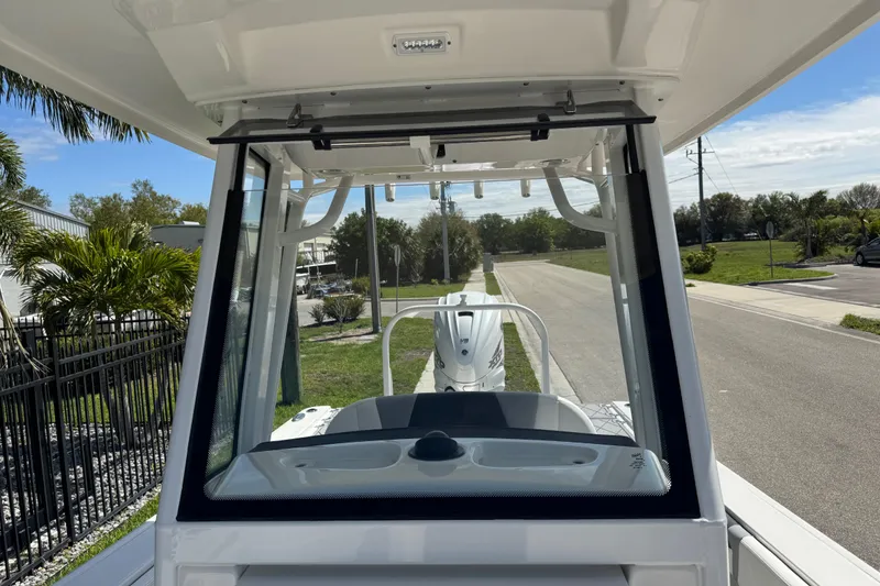 Slide: The Image of 2022 Robalo 266 Cayman boat windshield view with outdoor background. - 56