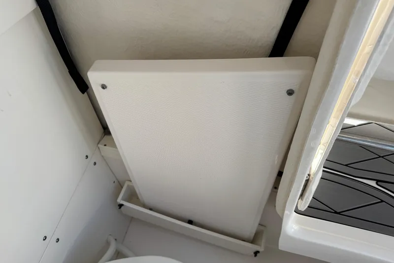 Slide: The Image of Interior view of 2022 Robalo 266 Cayman boat, showcasing a foldable seat. - 60