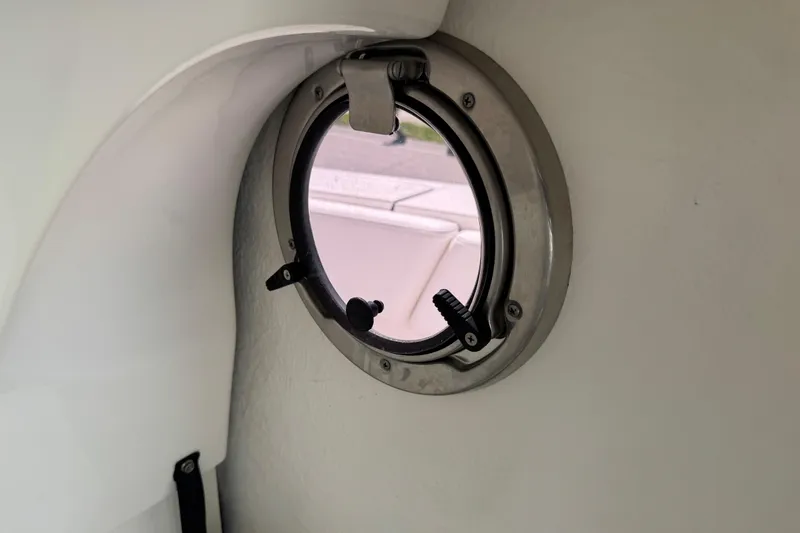 Slide: The Image of Porthole view inside 2022 Robalo 266 Cayman boat, showcasing sleek interior design. - 61