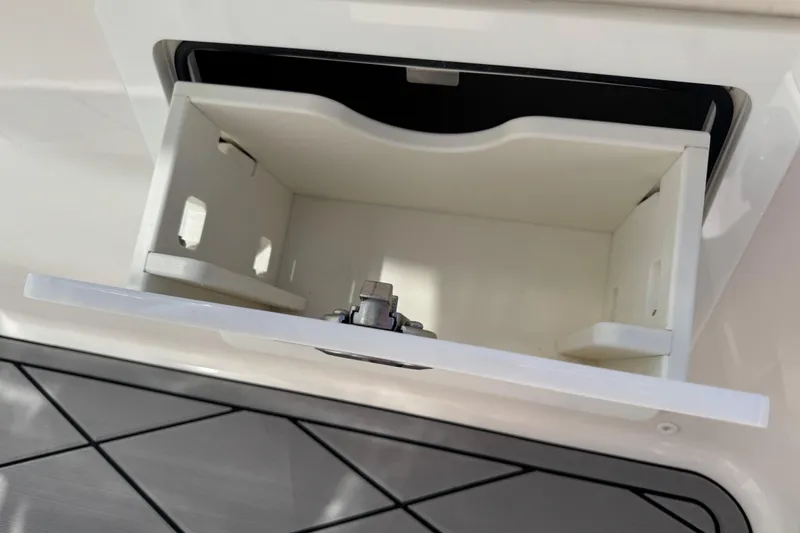 Slide: The Image of Open storage compartment on a 2022 Robalo 266 Cayman boat. - 62