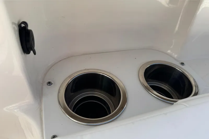 Slide: The Image of 2022 Robalo 266 Cayman boat cup holders with stainless steel rims. - 64