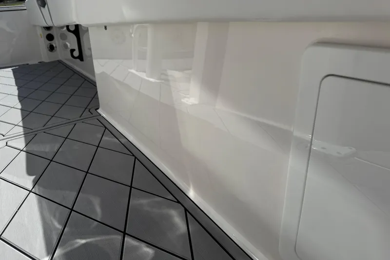 Slide: The Image of 2022 Robalo 266 Cayman boat interior with sleek flooring and storage compartment. - 67