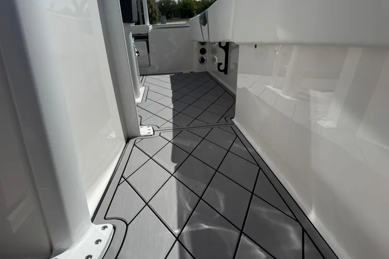 Slide: The Image of 2022 Robalo 266 Cayman boat interior with sleek, modern flooring design. - 68