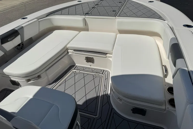 Slide: The Image of 2022 Robalo 266 Cayman boat interior with cushioned seating and storage compartments. - 73