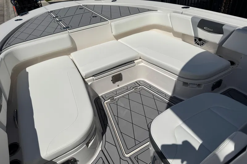 Slide: The Image of 2022 Robalo 266 Cayman boat interior with cushioned seating and storage compartments. - 74