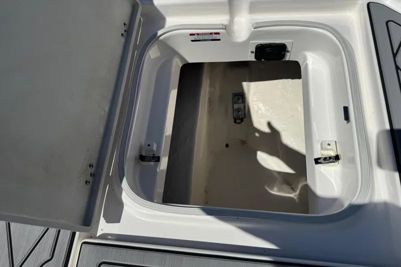 Slide: The Image of Open storage compartment on 2022 Robalo 266 Cayman boat deck. - 80