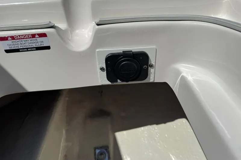 Slide: The Image of 2022 Robalo 266 Cayman boat detail with warning label and marine socket. - 81