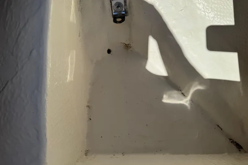 Slide: The Image of Interior compartment of a 2022 Robalo 266 Cayman boat, showing clean, white surface. - 82