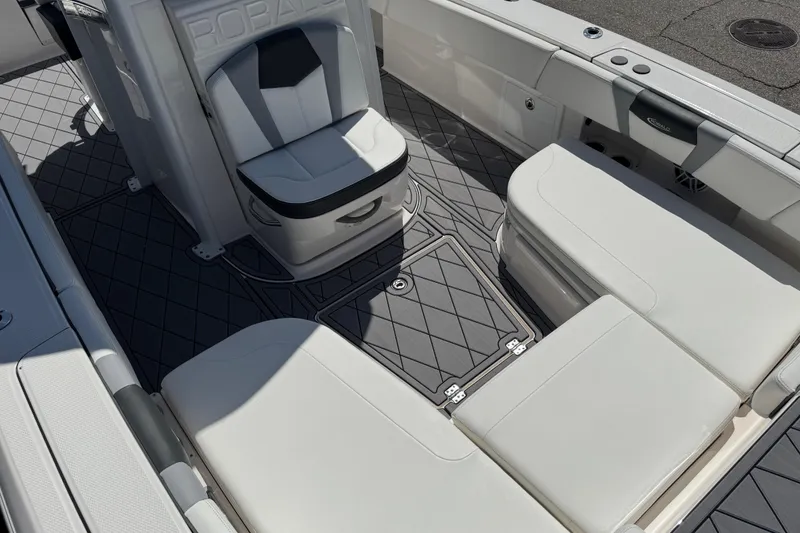 Slide: The Image of 2022 Robalo 266 Cayman boat interior with cushioned seating and non-slip flooring. - 86