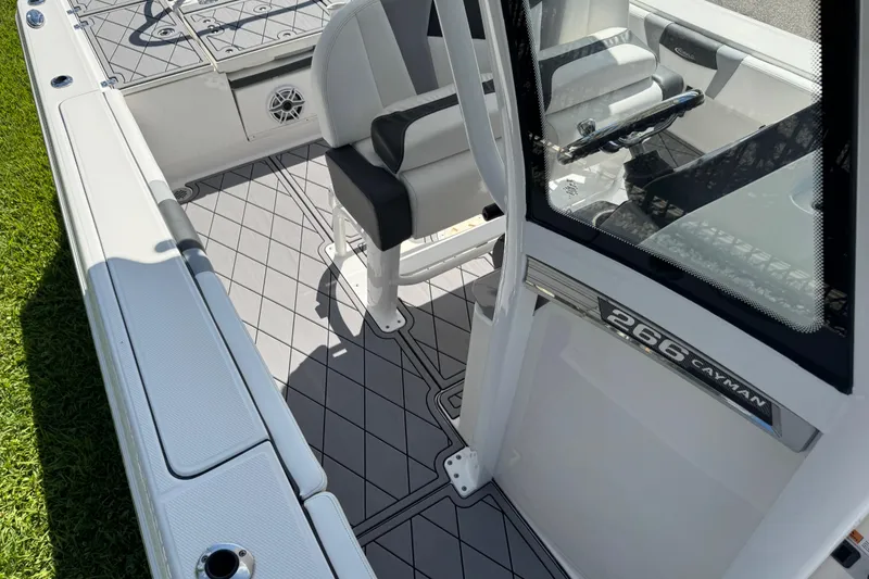 Slide: The Image of 2022 Robalo 266 Cayman boat interior with seating and console details. - 89