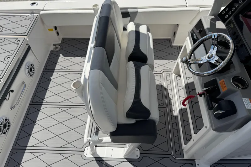 Slide: The Image of 2022 Robalo 266 Cayman boat interior with steering wheel and seating. - 90