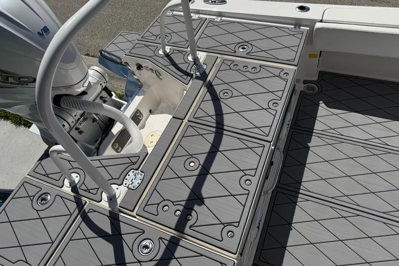Slide: The Image of 2022 Robalo 266 Cayman boat deck with textured flooring and engine view. - 92