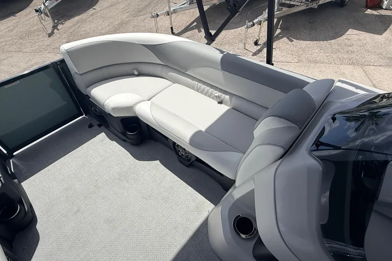 Slide: The Image of 2026 Avalon 2385 LSZ Rear Fish Tri Toon boat interior with plush seating and cup holders. - 13