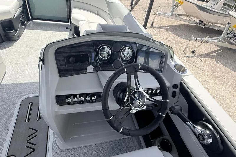 Slide: The Image of 2026 Avalon 2385 LSZ Tri Toon boat dashboard with modern controls and steering wheel. - 22