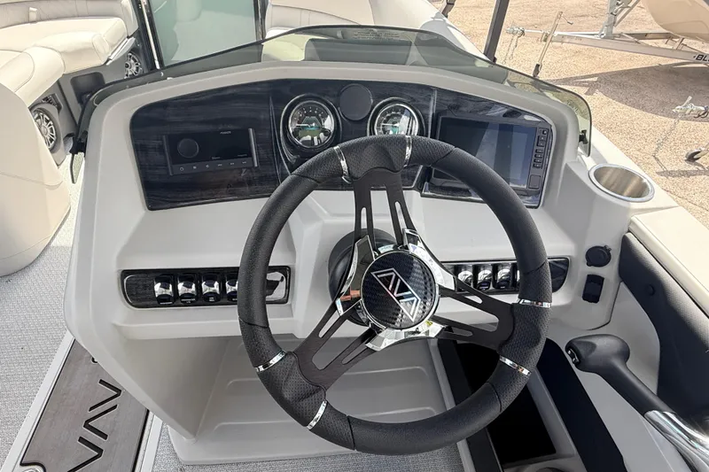 Slide: The Image of Steering console of 2026 Avalon 2385 LSZ Rear Fish Tri Toon boat, featuring modern controls. - 23