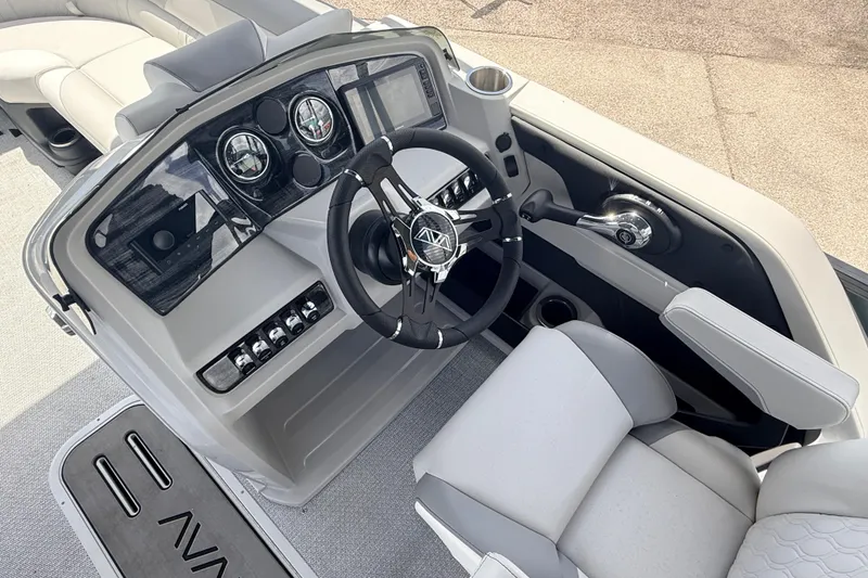 Slide: The Image of 2026 Avalon 2385 LSZ Rear Fish boat dashboard with modern controls and steering wheel. - 24
