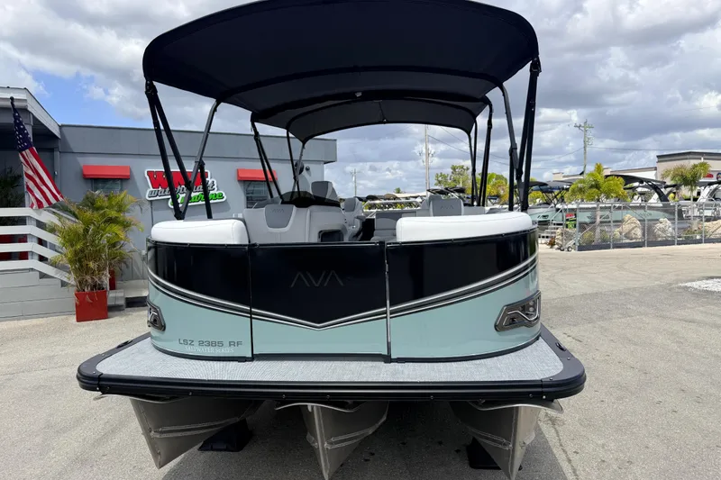 Slide: The Image of 2026 Avalon 2385 LSZ Rear Fish Tri Toon boat with canopy, parked outdoors. - 3