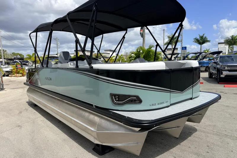 Slide: The Image of 2026 Avalon 2385 LSZ Rear Fish Tri Toon boat with high performance features, parked outdoors. - 4