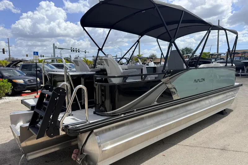 Slide: The Image of 2026 Avalon 2385 LSZ Rear Fish Tri Toon boat with canopy, parked outdoors. - 5