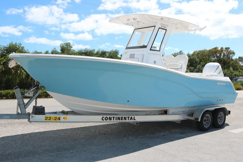 The Image of 2026 Sea Fox 248 Commander boat on trailer, light blue hull, sunny day. - 1