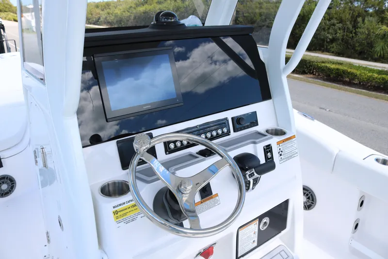 Slide: The Image of 2026 Sea Fox 248 Commander boat dashboard with steering wheel and navigation screen. - 10