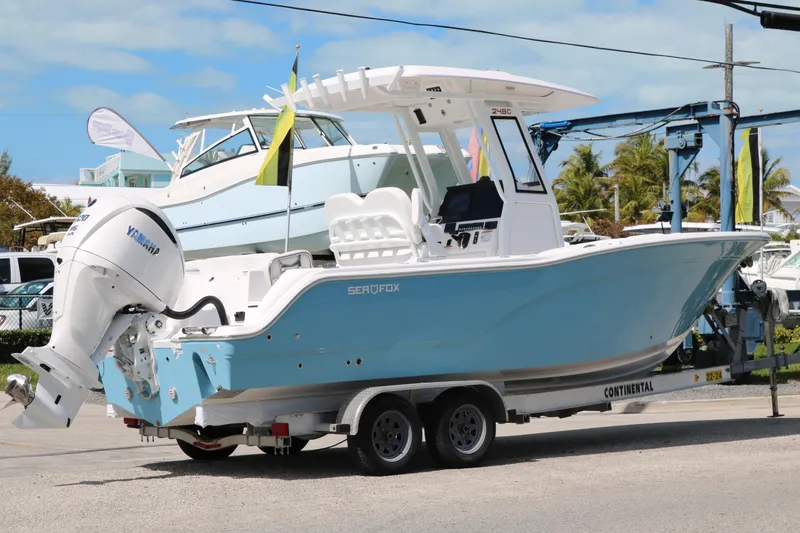 Slide: The Image of 2026 Sea Fox 248 Commander boat on trailer with Yamaha engine, parked outdoors. - 4