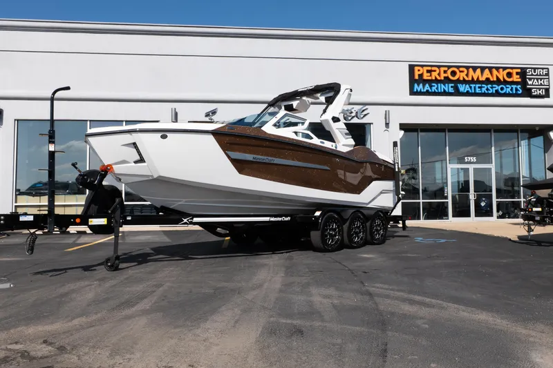 The Image of 2026 MasterCraft X24 boat on trailer at Performance Marine Watersports dealership. - 0