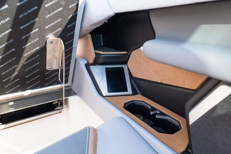 Slide: The Image of Interior of 2026 MasterCraft X24 boat featuring modern design and cup holders. - 27