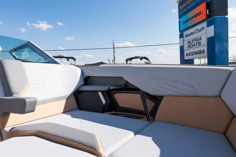 Slide: The Image of 2026 MasterCraft X24 boat interior with modern seating, under a clear blue sky. - 31
