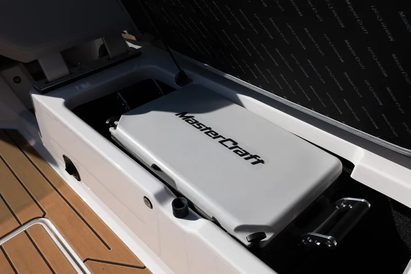 Slide: The Image of 2026 MasterCraft X24 boat storage compartment with branded cover and sleek design. - 35