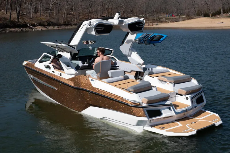 Slide: The Image of 2026 MasterCraft X24 boat on a lake, featuring sleek design and modern amenities. - 49