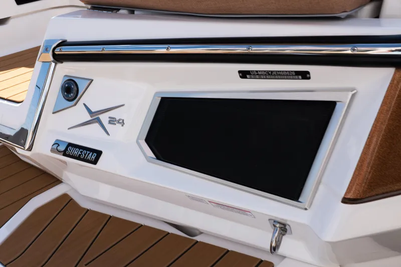 Slide: The Image of 2026 MasterCraft X24 boat interior with luxurious seating and teak-style flooring. - 8