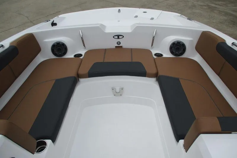 Slide: The Image of 2026 Tahoe 2150 boat interior with brown and black seating, cup holders, and speakers. - 12