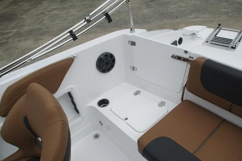 Slide: The Image of Interior of 2026 Tahoe 2150 boat with brown seating and storage compartments. - 14