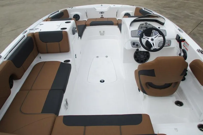 Slide: The Image of 2026 Tahoe 2150 boat interior with brown and black seating, modern dashboard, and steering wheel. - 5