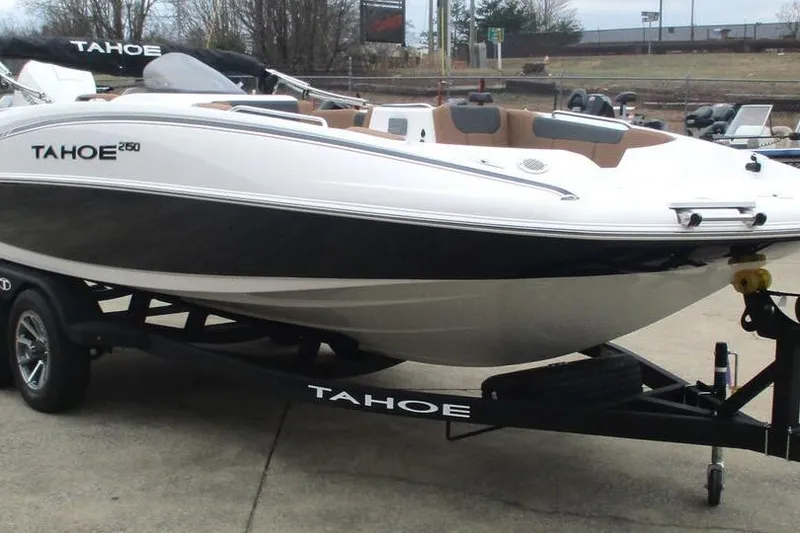 Slide: The Image of 2026 Tahoe 2150 boat on trailer, sleek design, white and black exterior. - 8