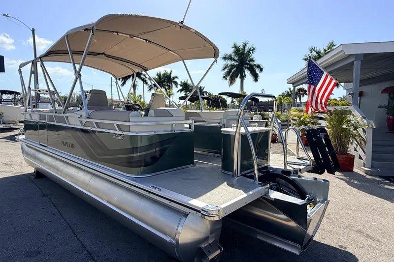 Slide: The Image of 2026 Avalon 2385 Venture 85 Quad Lounger Tri Toon boat with canopy and American flag. - 10